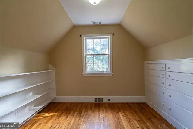 a view of room with window and wooden floor