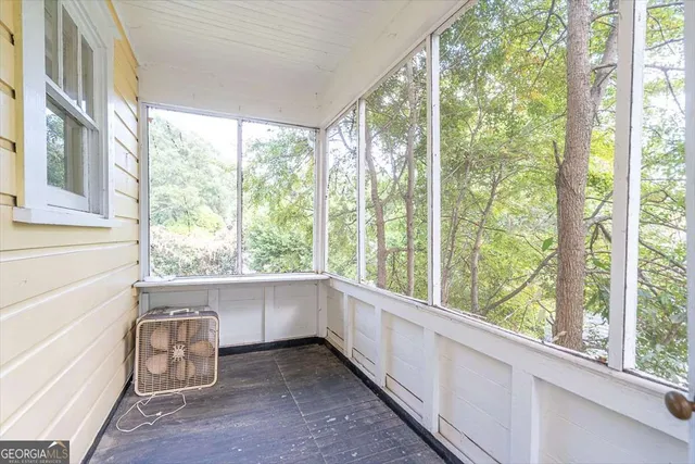 a view of a room that has a bed and chair