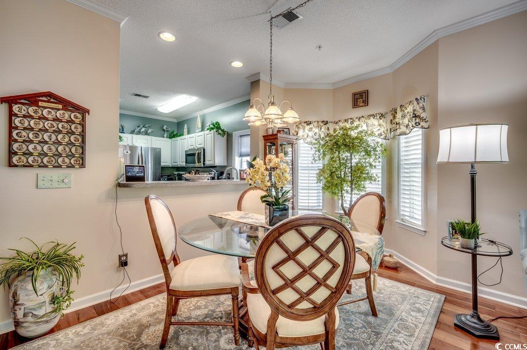 1533 Lanterns Rest Road, Unit 201 Myrtle Beach, SC 29579 - Photo 5 of 40 Dining area with a textured ceiling, a notable cha