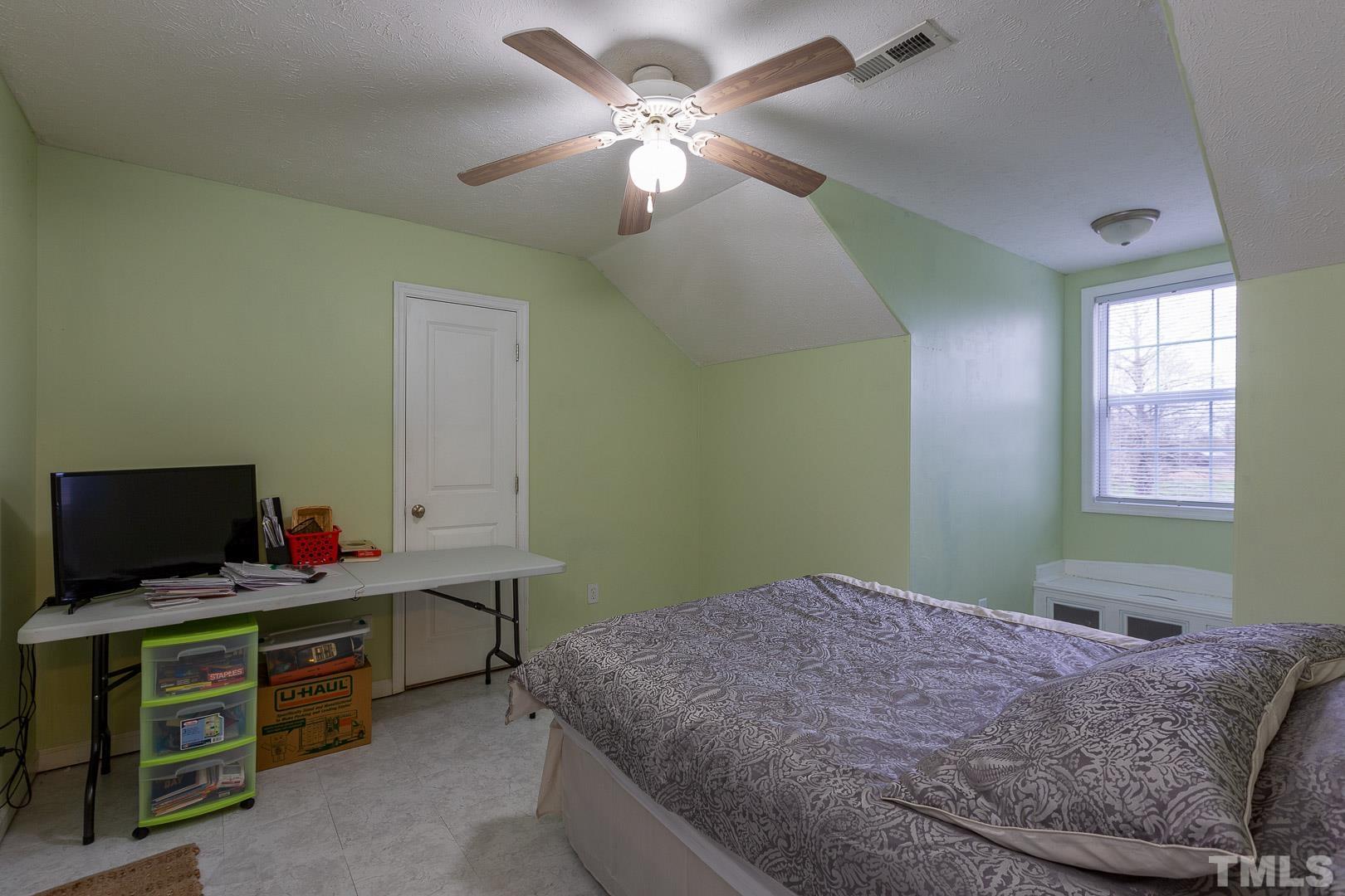 338 Green Path Road Godwin, NC 28344 - Photo 22 of 28 a bedroom with a bed and a flat screen tv