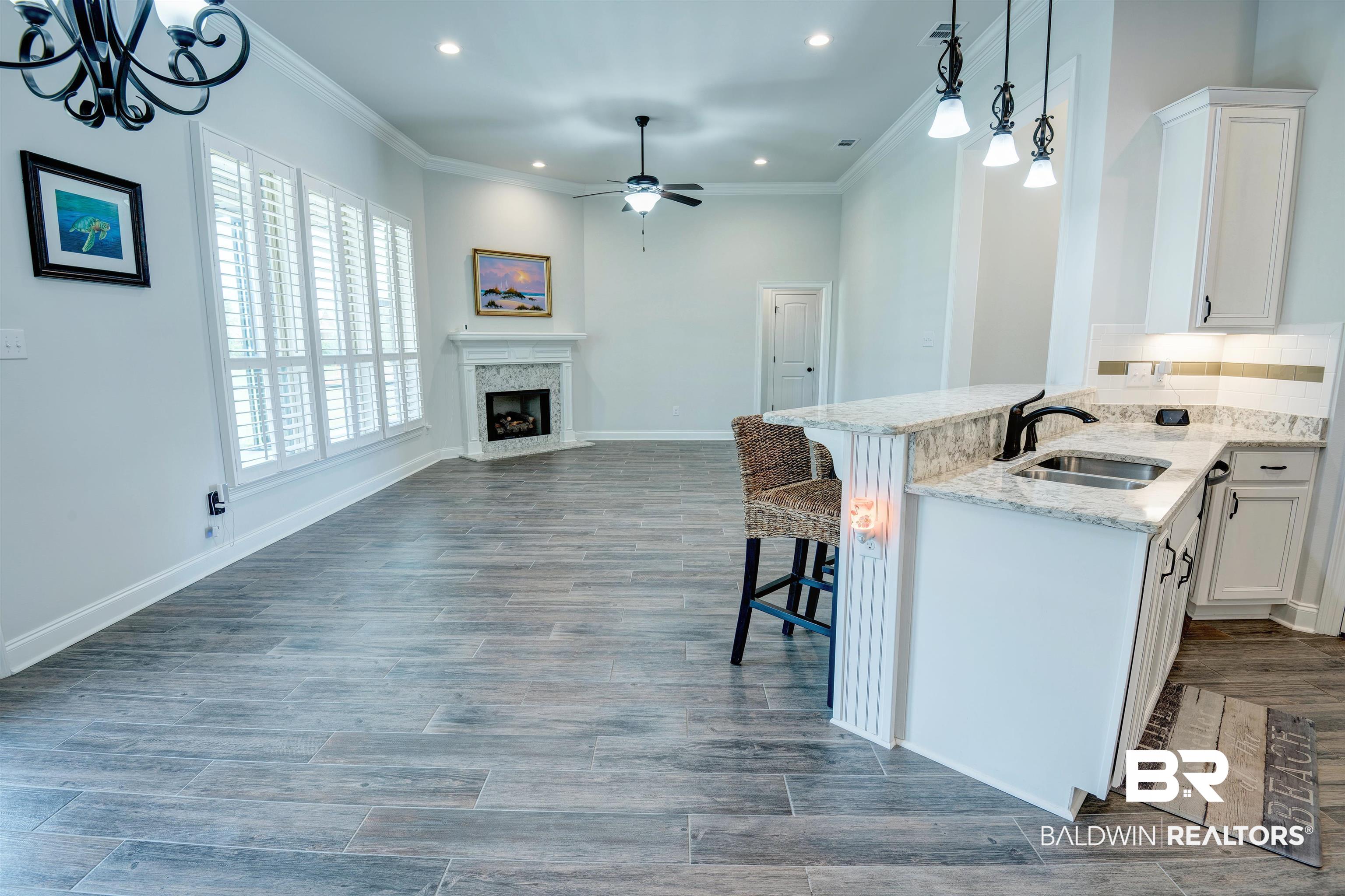 9843 Chipper Lane Foley, AL 36535 - Photo 33 of 34 Kitchen with a sink, a ceiling fan, open floor plan, recessed lighting, and white cabinets