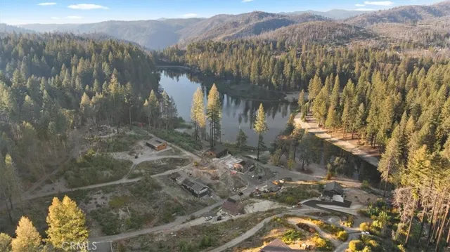 a view of a yard with wooden fence