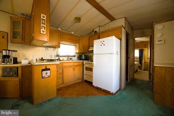 a utility room with refrigerator and washer
