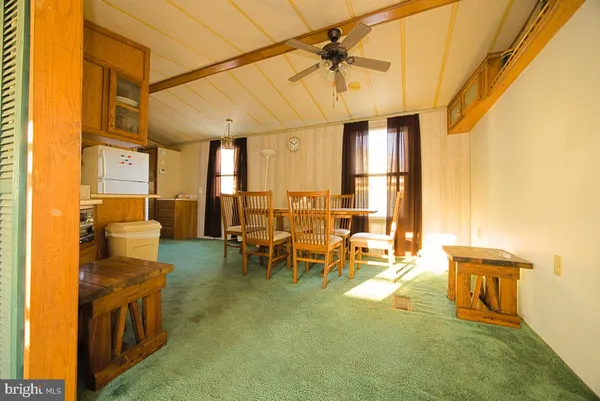 a living room with couches a flat screen tv and chairs