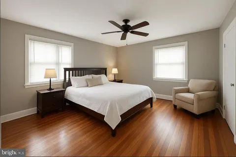 a bedroom with a bed couch and window