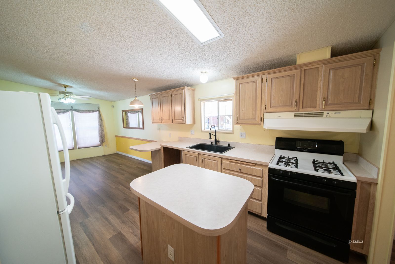 1219 South Garth Street Ridgecrest, CA 93555 - Photo 9 of 23 a kitchen with a stove a sink and a refrigerator
