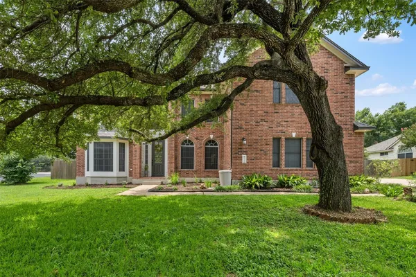 a front view of house with yard and green space
