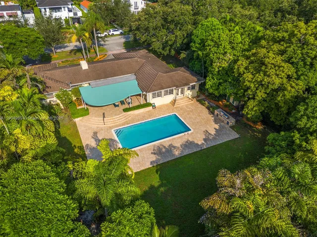 an aerial view of residential houses with outdoor space and street view