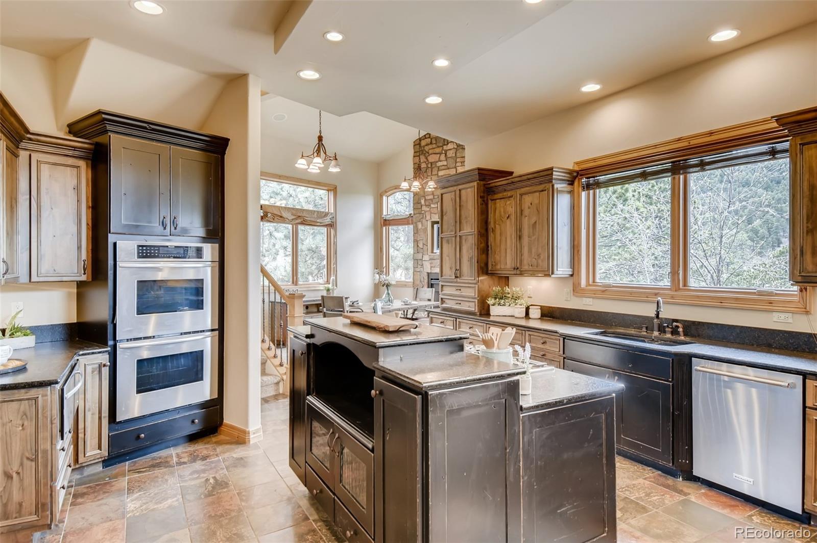1265 Silver Rock Lane Evergreen, CO 80439 - Photo 11 of 35 a kitchen with a sink stove and refrigerator