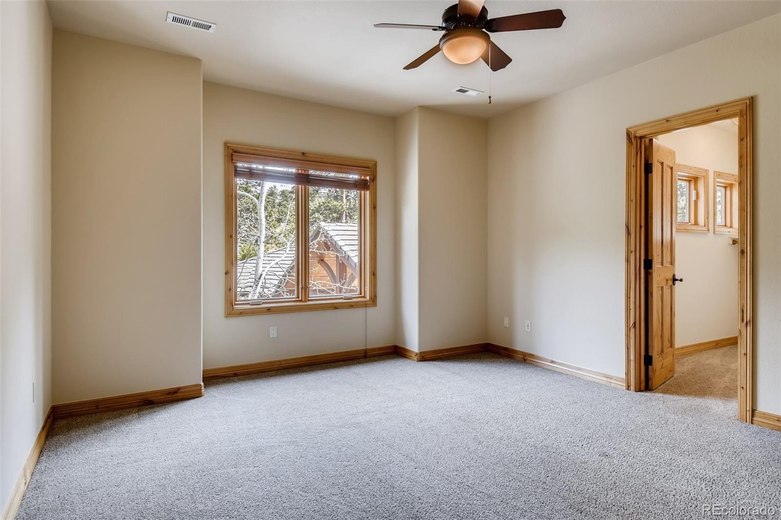 1265 Silver Rock Lane Evergreen, CO 80439 - Photo 19 of 35 a view of an empty room with a window