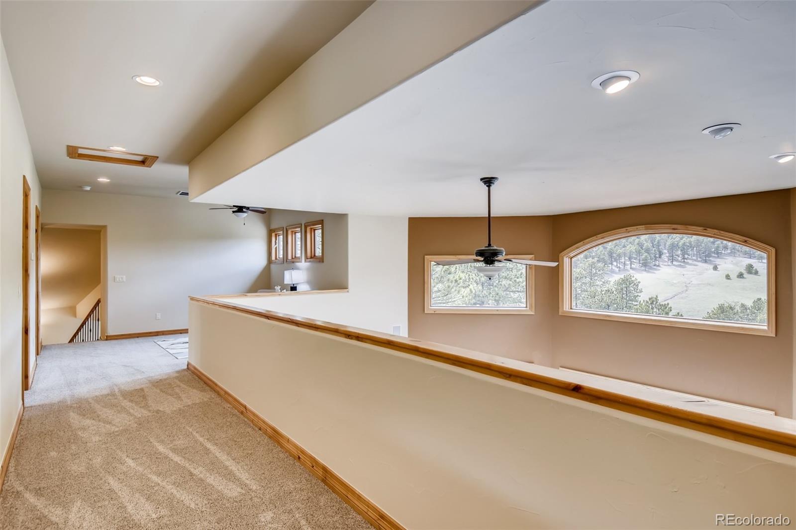 1265 Silver Rock Lane Evergreen, CO 80439 - Photo 21 of 35 a view of a living room and bedroom with furniture