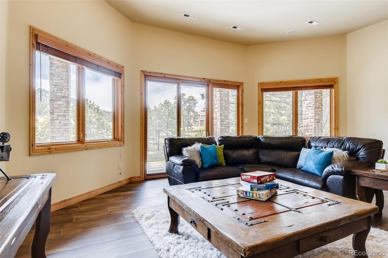 1265 Silver Rock Lane Evergreen, CO 80439 - Photo 23 of 35 a living room with furniture and a large window