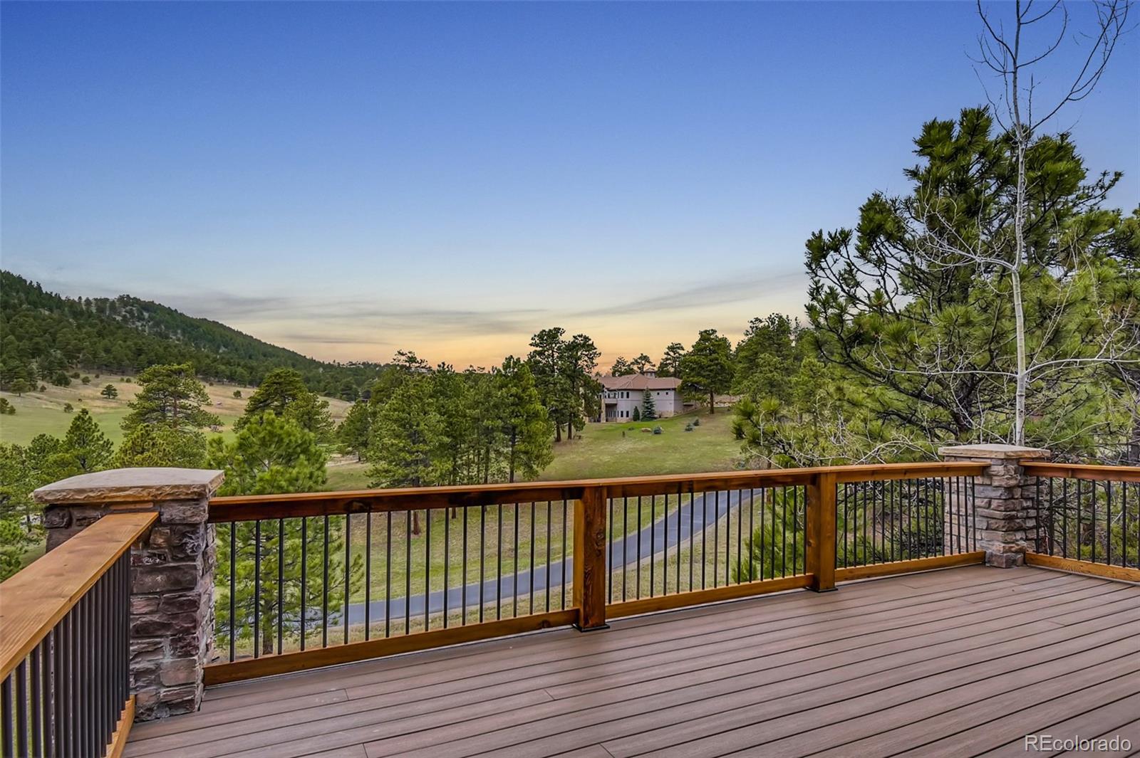 1265 Silver Rock Lane Evergreen, CO 80439 - Photo 28 of 35 a view of a balcony with wooden floor and fence