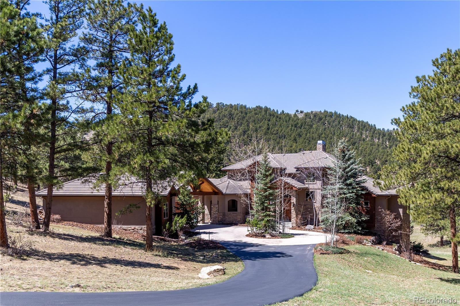 1265 Silver Rock Lane Evergreen, CO 80439 - Photo 3 of 35 a view of a house with swimming pool and sitting area