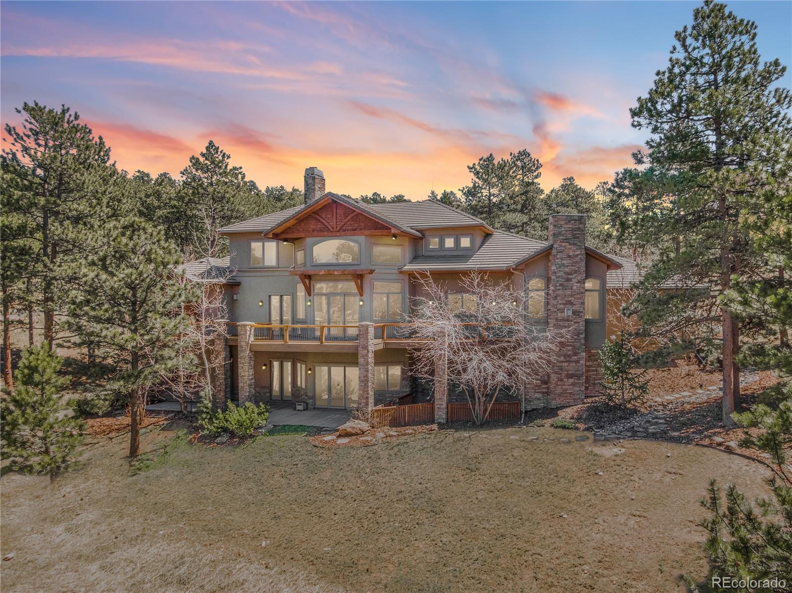 1265 Silver Rock Lane Evergreen, CO 80439 - Photo 34 of 35 a front view of a house with a yard
