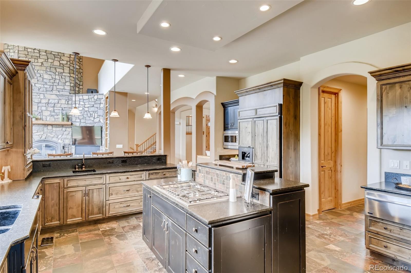 1265 Silver Rock Lane Evergreen, CO 80439 - Photo 10 of 35 a kitchen with stainless steel appliances granite countertop a stove a sink and a refrigerator