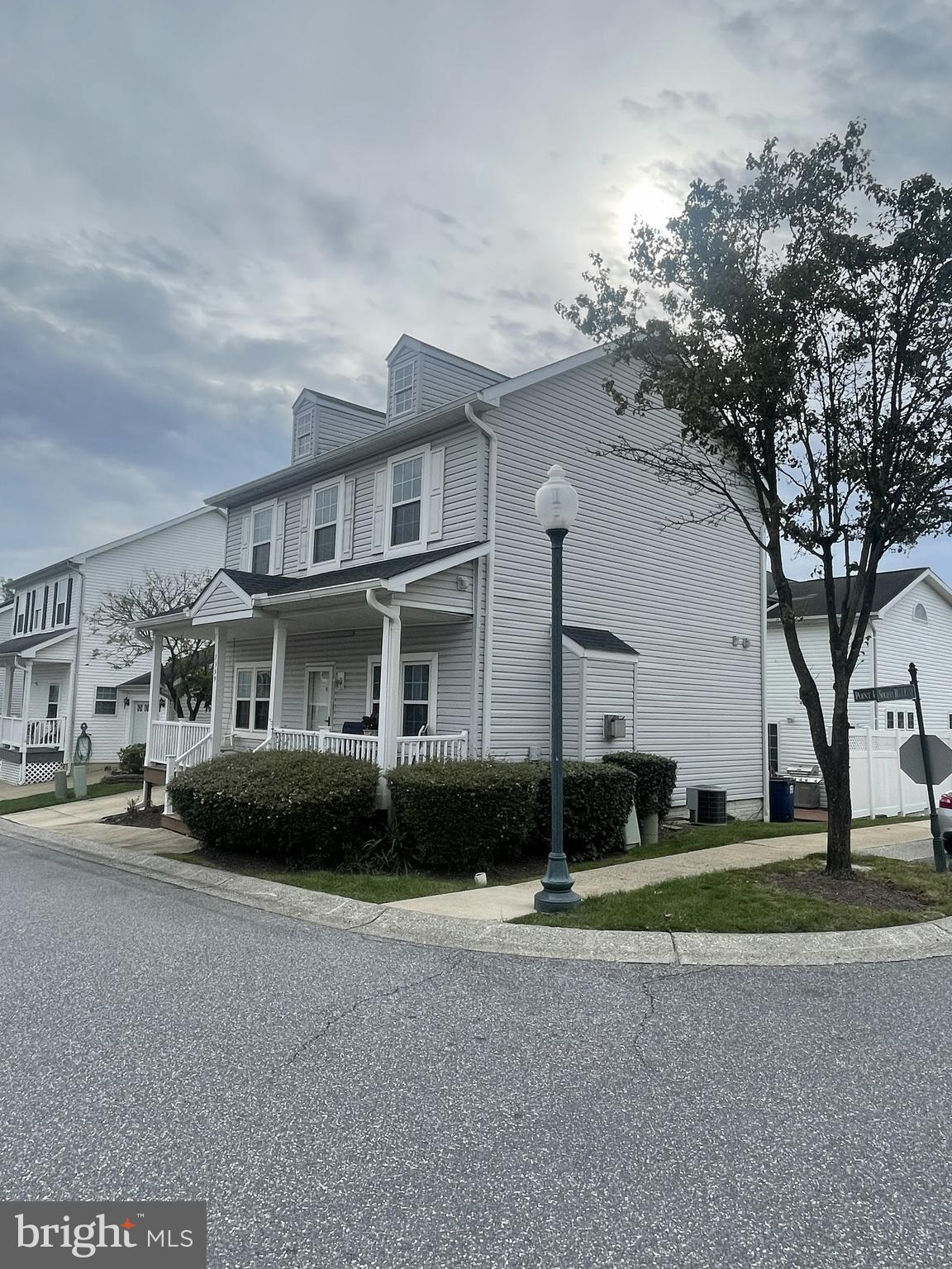 7359 Point Patience Way Elkridge, MD 21075 - Photo 11 of 23 a front view of a house with a garden