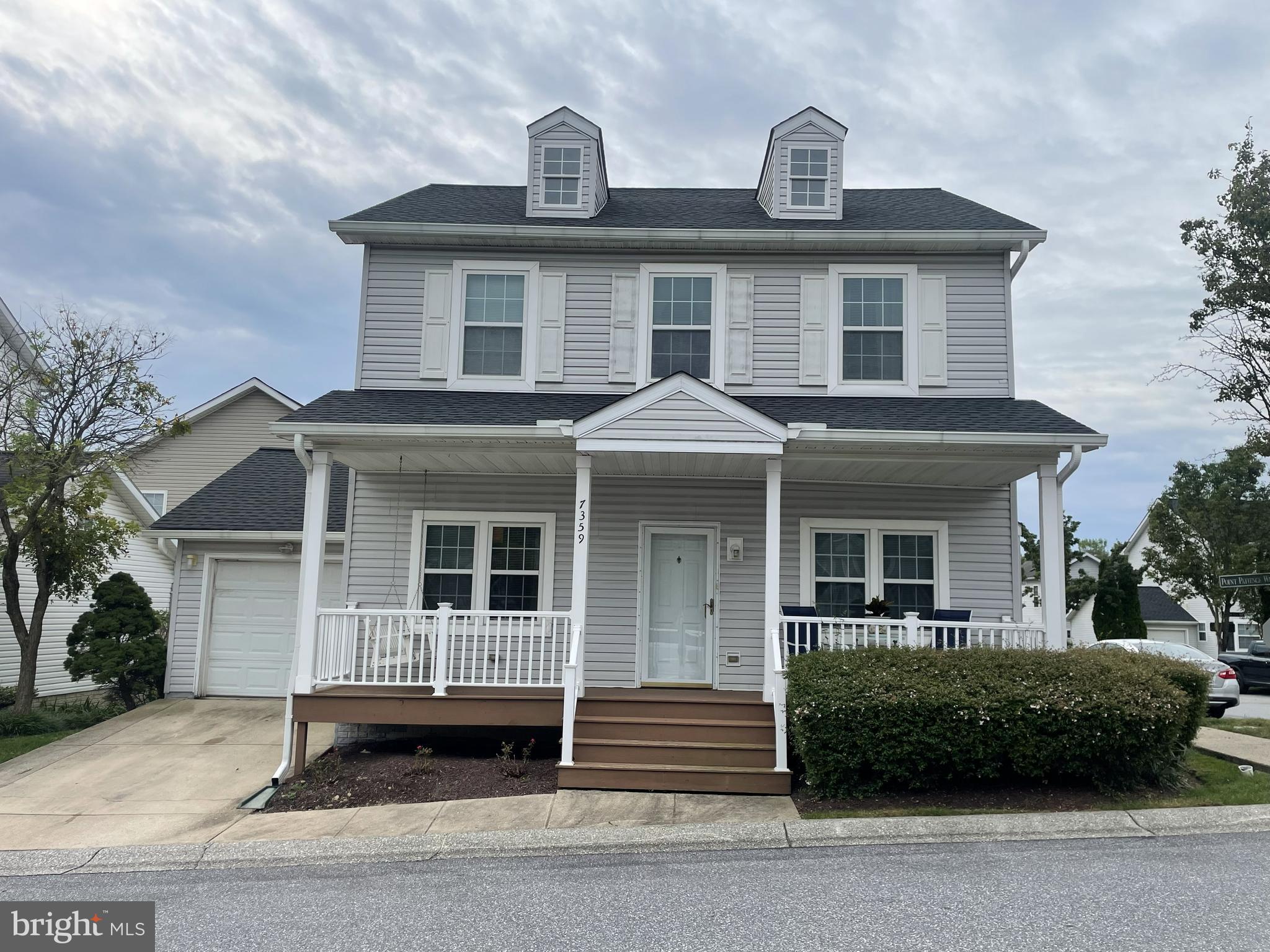 7359 Point Patience Way Elkridge, MD 21075 - Photo 13 of 23 a front view of a house with a garden