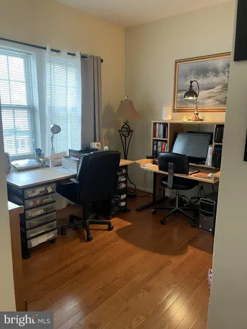 a view of a workspace with furniture and a window