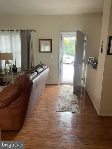 a living room with hard wood flooring and a couch