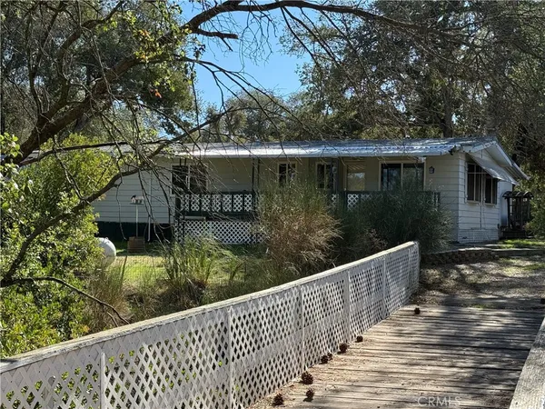 a view of a house with wooden fence