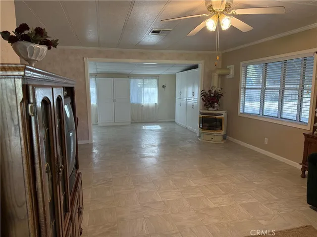 a view of a big room with windows furniture and front door