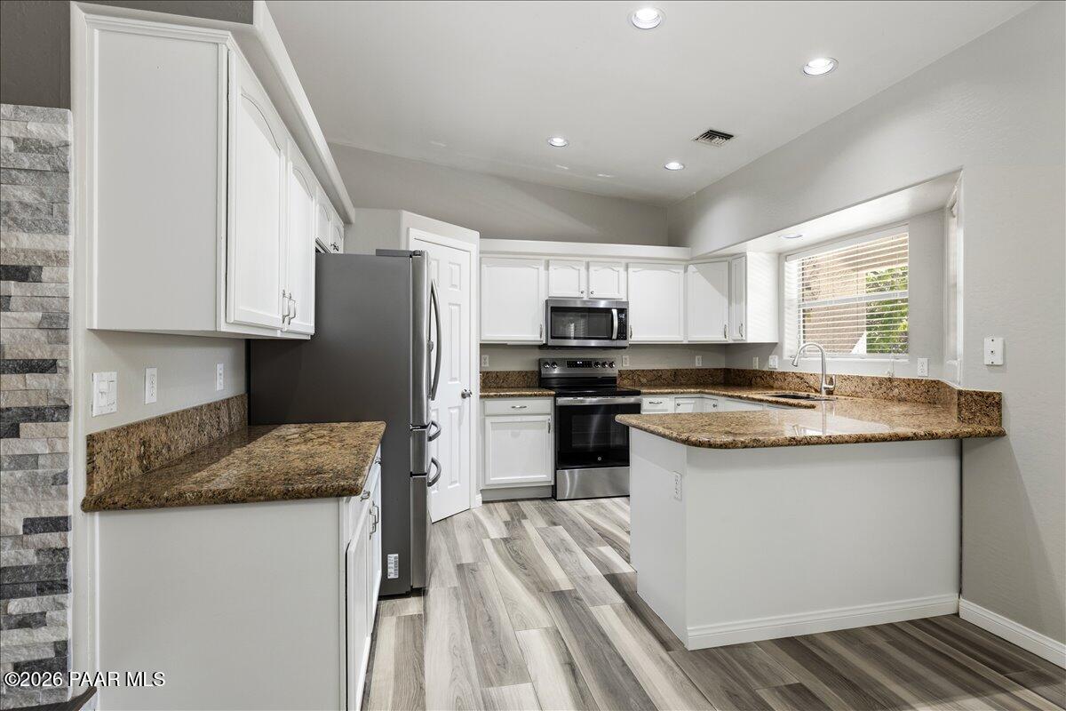 4701 North Spring Drive Prescott Valley, AZ 86314 - Photo 11 of 31 a kitchen with granite countertop a sink stove and refrigerator