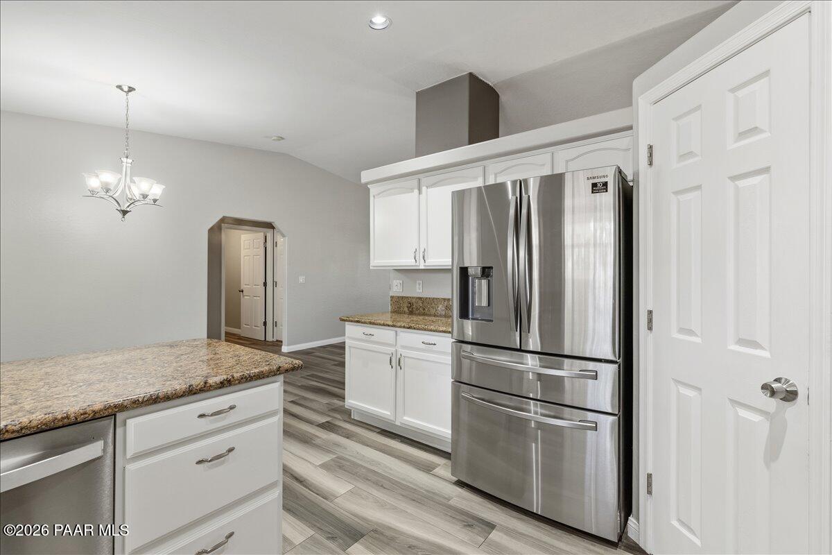 4701 North Spring Drive Prescott Valley, AZ 86314 - Photo 14 of 31 a kitchen with granite countertop stainless steel appliances a refrigerator and cabinets