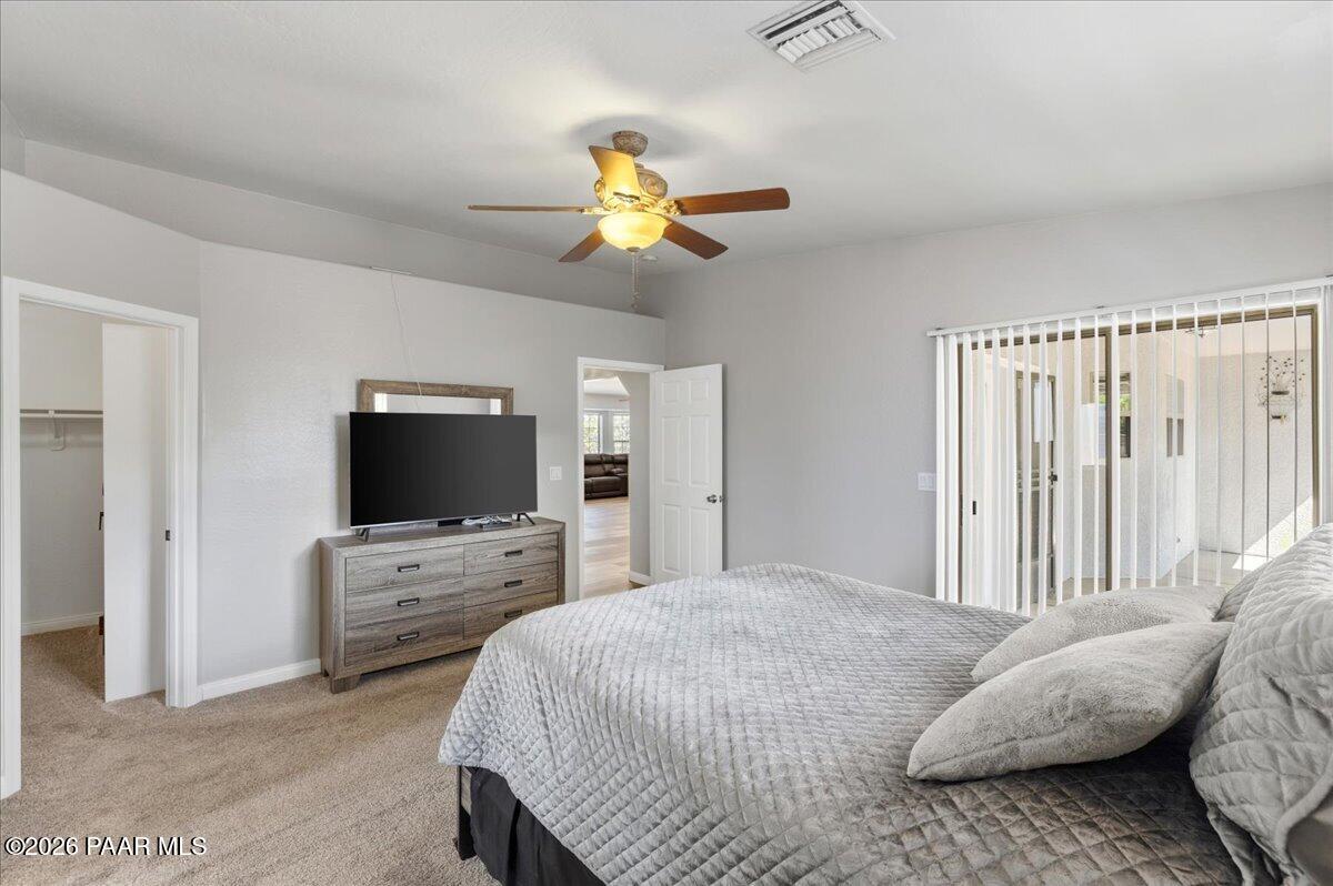 4701 North Spring Drive Prescott Valley, AZ 86314 - Photo 16 of 31 a bedroom with a bed and a flat screen tv