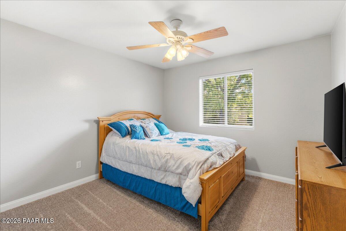 4701 North Spring Drive Prescott Valley, AZ 86314 - Photo 20 of 31 a bed sitting in a bedroom next to a window