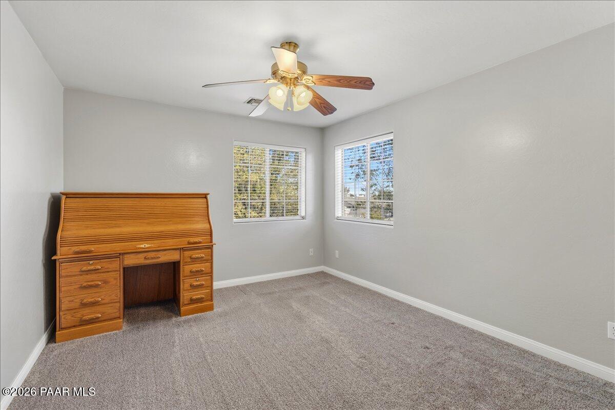 4701 North Spring Drive Prescott Valley, AZ 86314 - Photo 22 of 31 an empty room with windows and fireplace