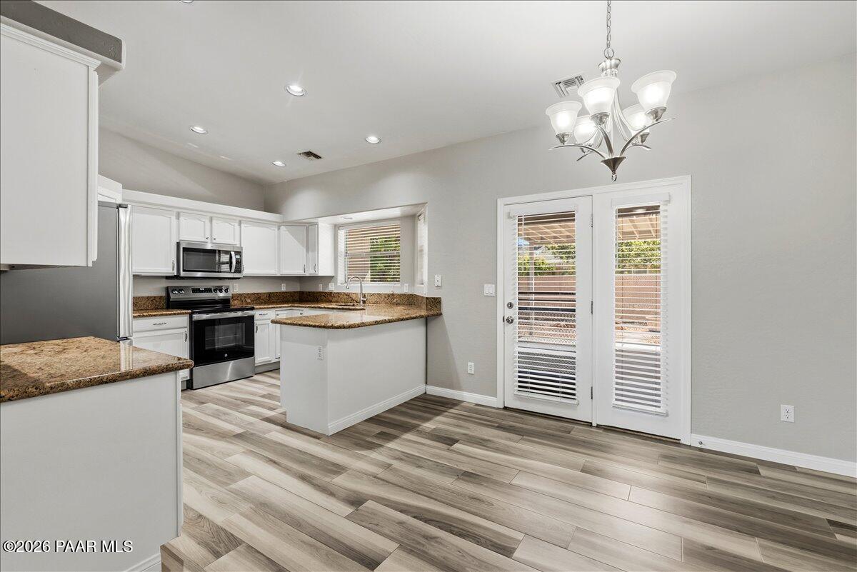 4701 North Spring Drive Prescott Valley, AZ 86314 - Photo 10 of 31 a large kitchen with kitchen island a sink stainless steel appliances and cabinets