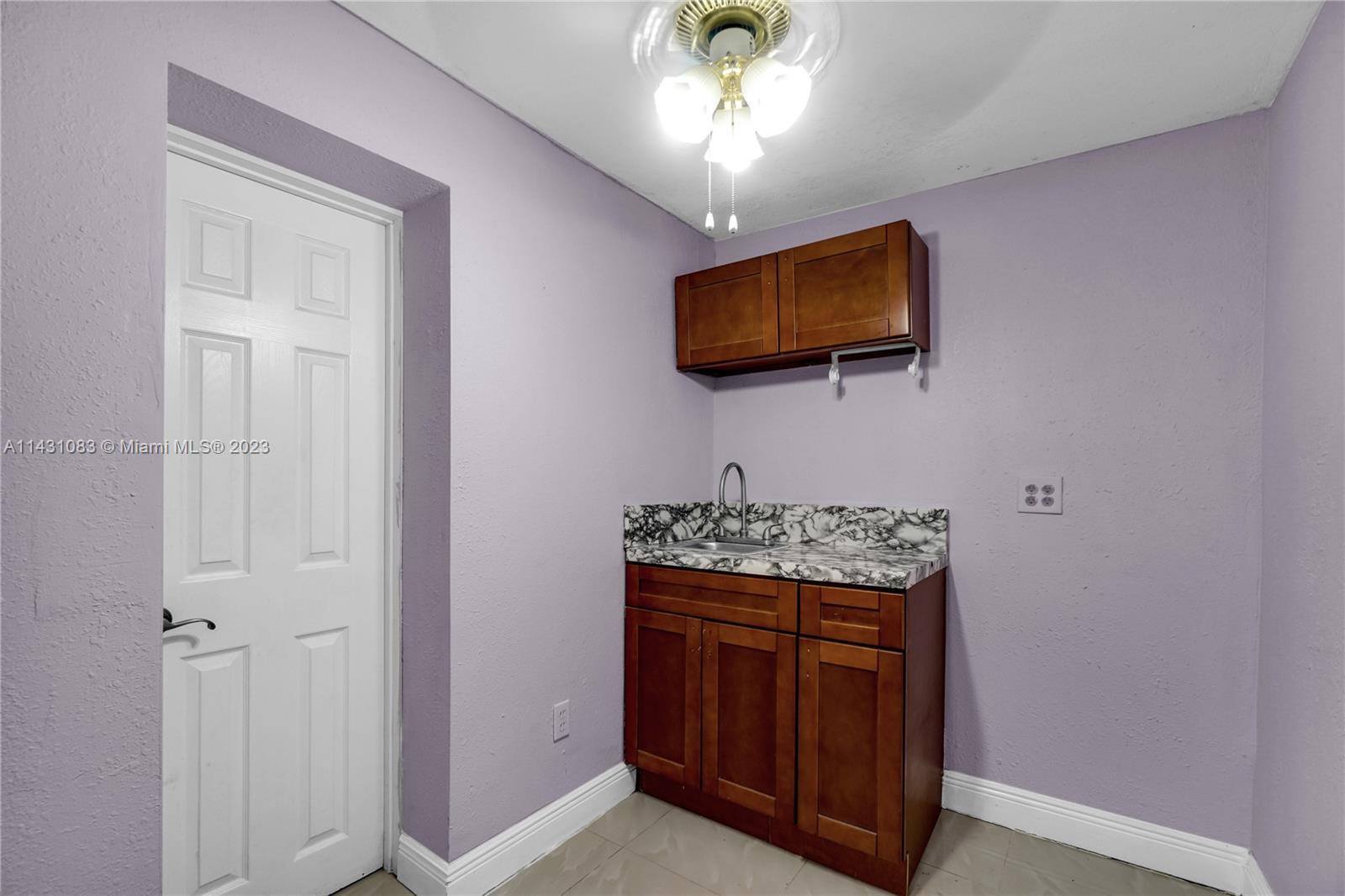 12371 Southwest 191st Street Miami, FL 33177 - Photo 11 of 19 a room with a flat screen tv and kitchen view