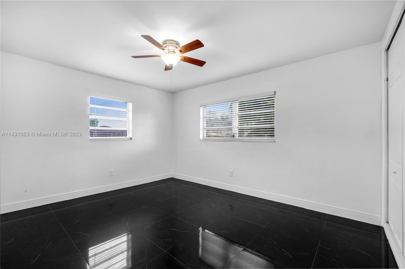 12371 Southwest 191st Street Miami, FL 33177 - Photo 13 of 19 a view of a big room with wooden floor and windows