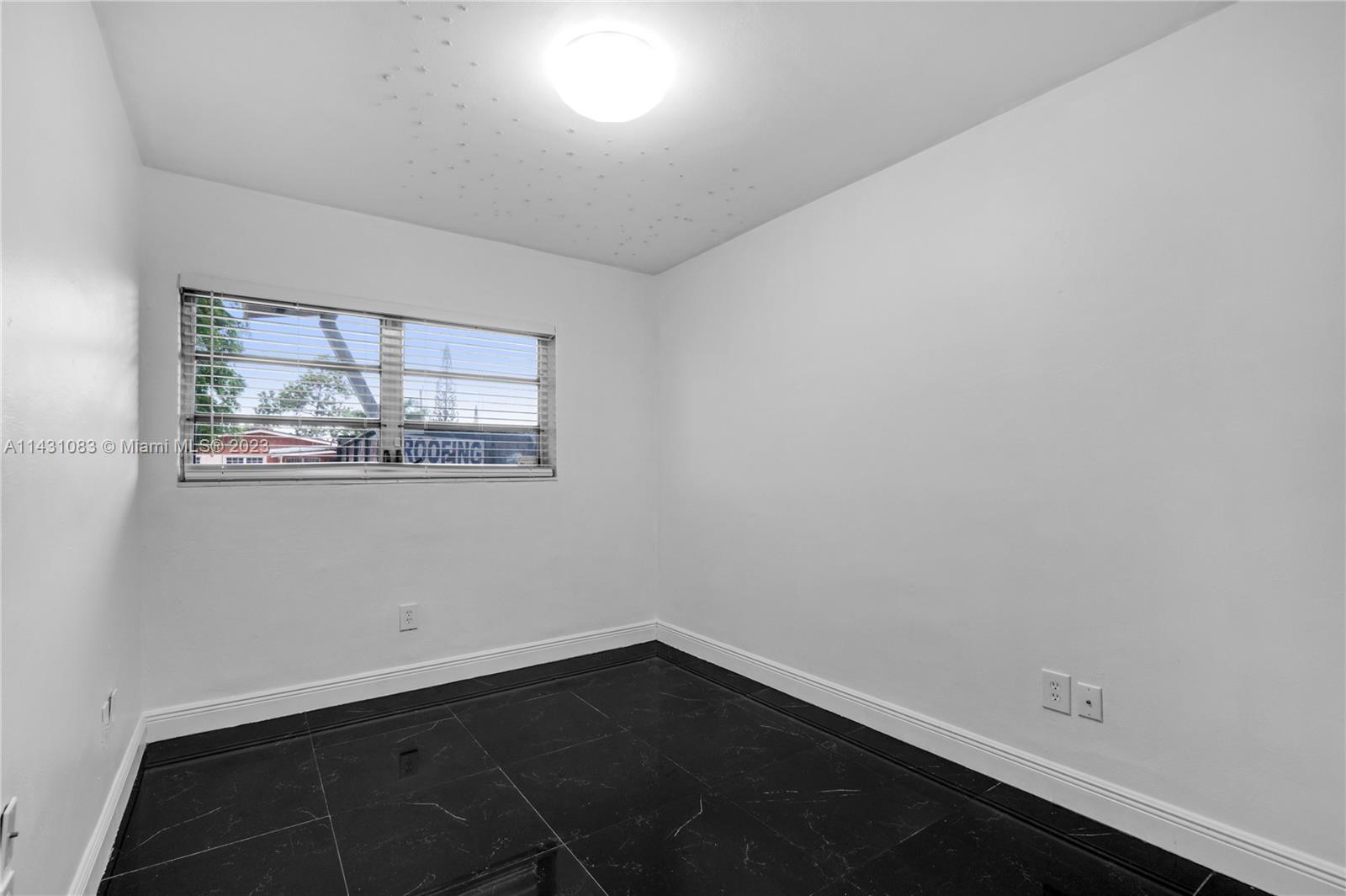 12371 Southwest 191st Street Miami, FL 33177 - Photo 16 of 19 an empty room with wooden floor and windows