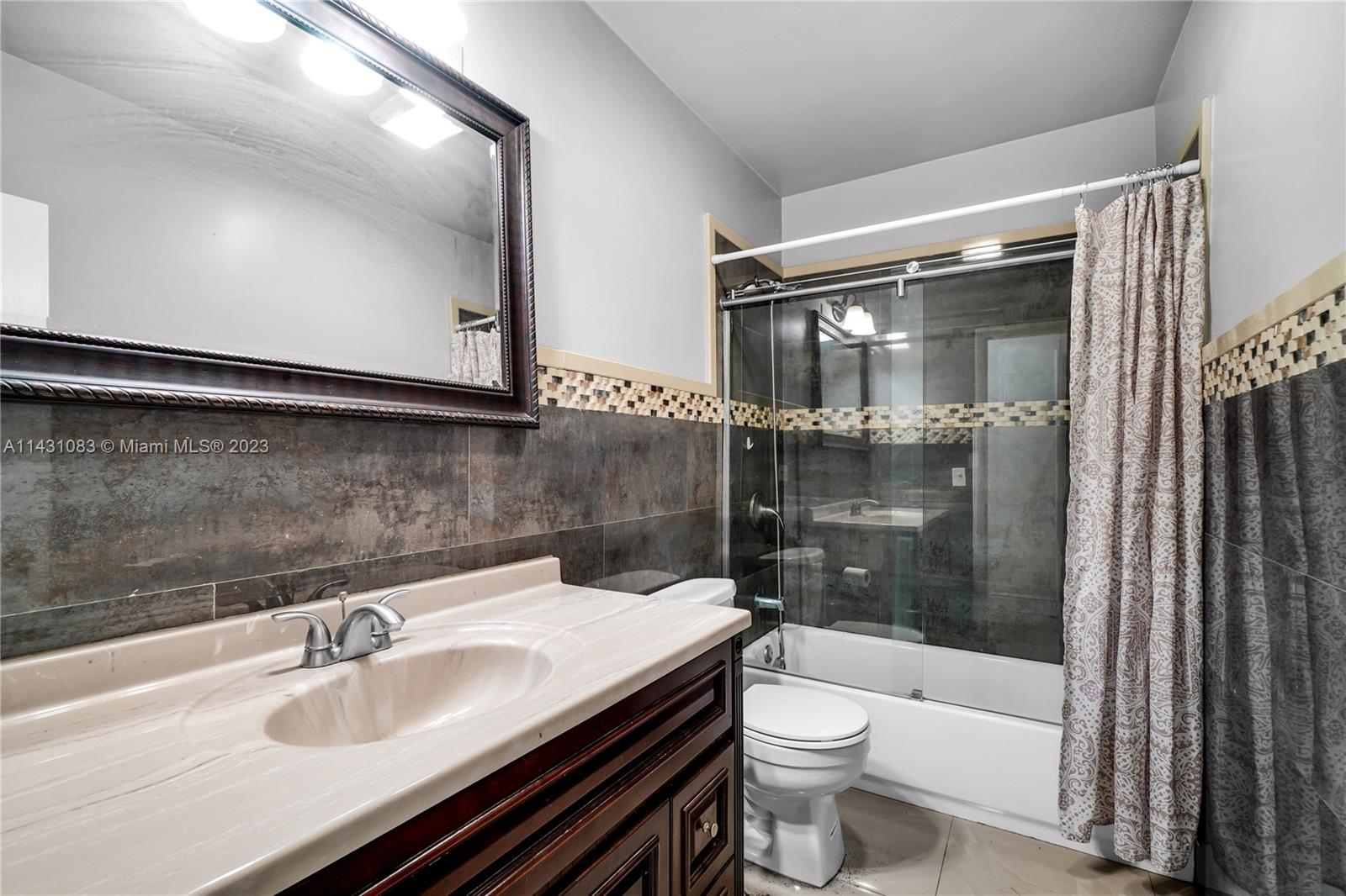 12371 Southwest 191st Street Miami, FL 33177 - Photo 19 of 19 a bathroom with a sink a toilet and shower