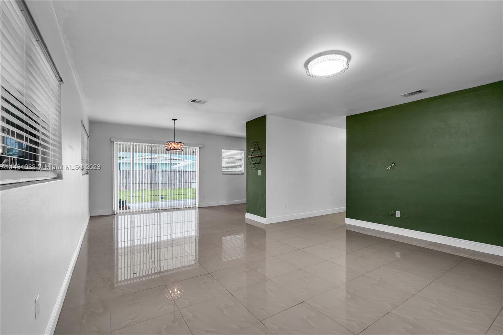 12371 Southwest 191st Street Miami, FL 33177 - Photo 2 of 19 an empty room with windows