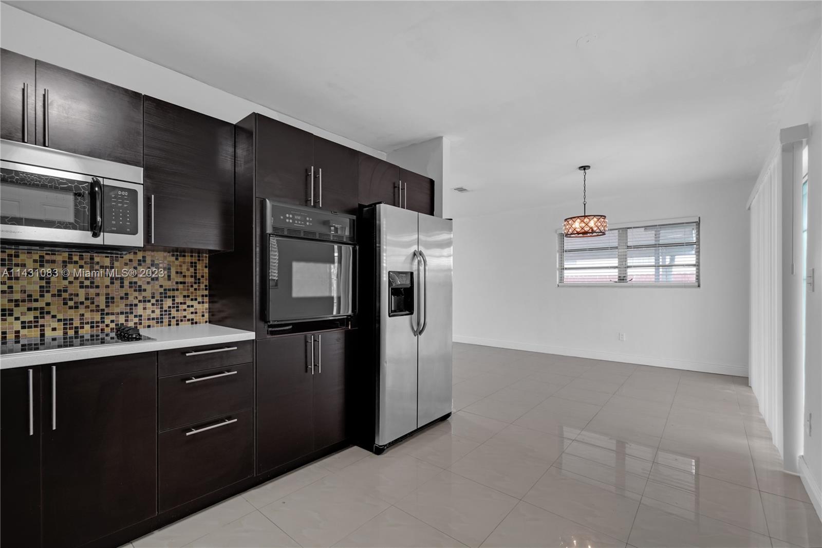 12371 Southwest 191st Street Miami, FL 33177 - Photo 6 of 19 a kitchen with stainless steel appliances granite countertop a refrigerator and a stove top oven