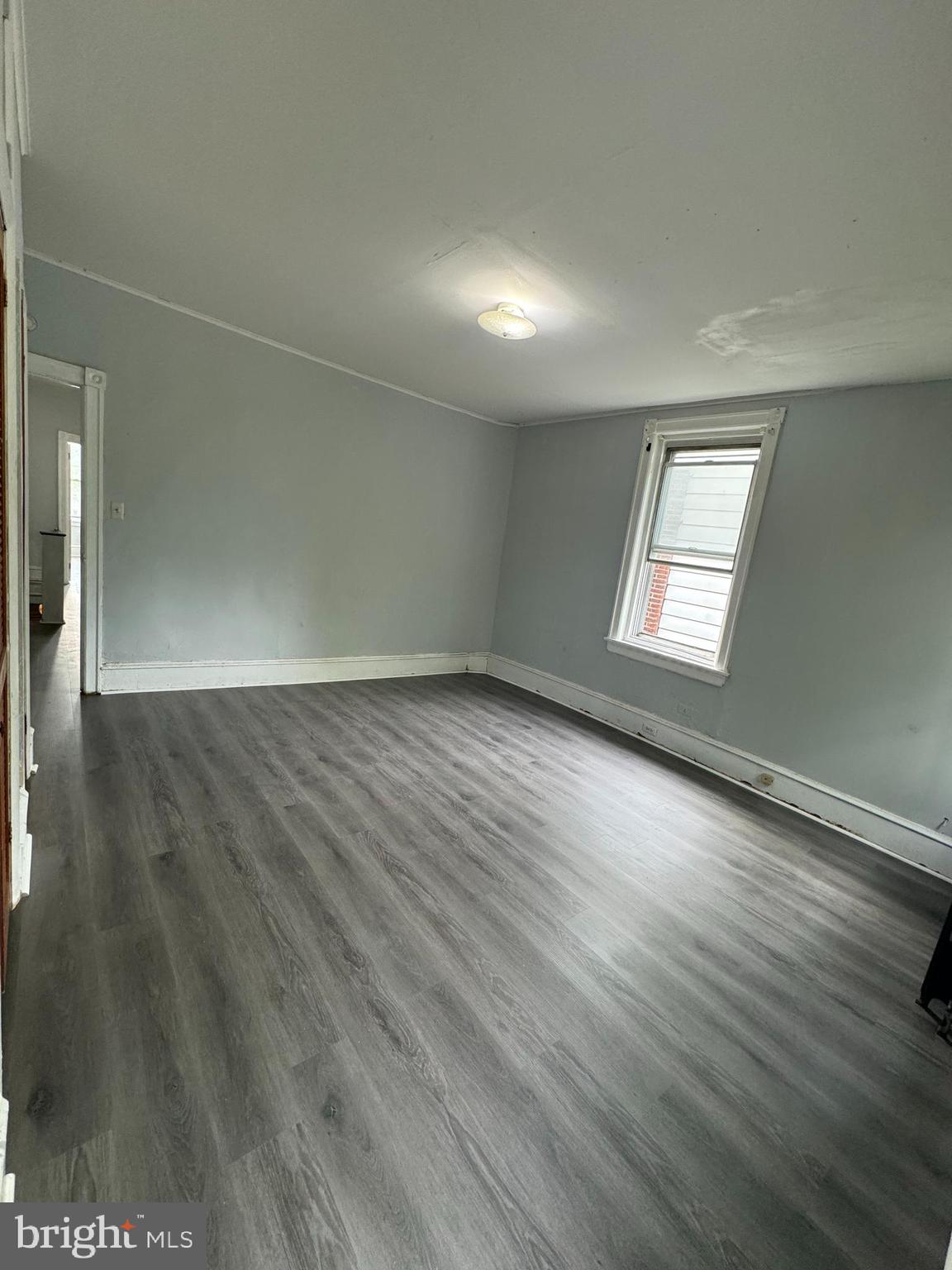 4660 Castor Avenue, Unit 2 Philadelphia, PA 19124 - Photo 7 of 11 an empty room with wooden floor and windows