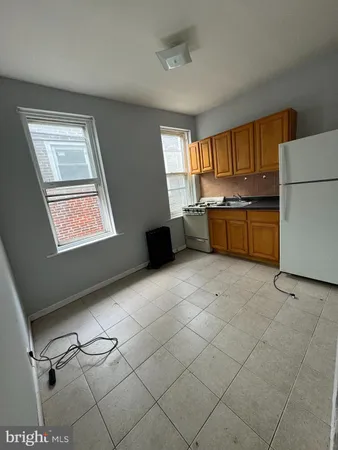a kitchen with granite countertop cabinets a sink a window and stainless steel appliances