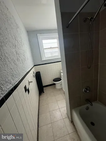 a bathroom with a bathtub and shower