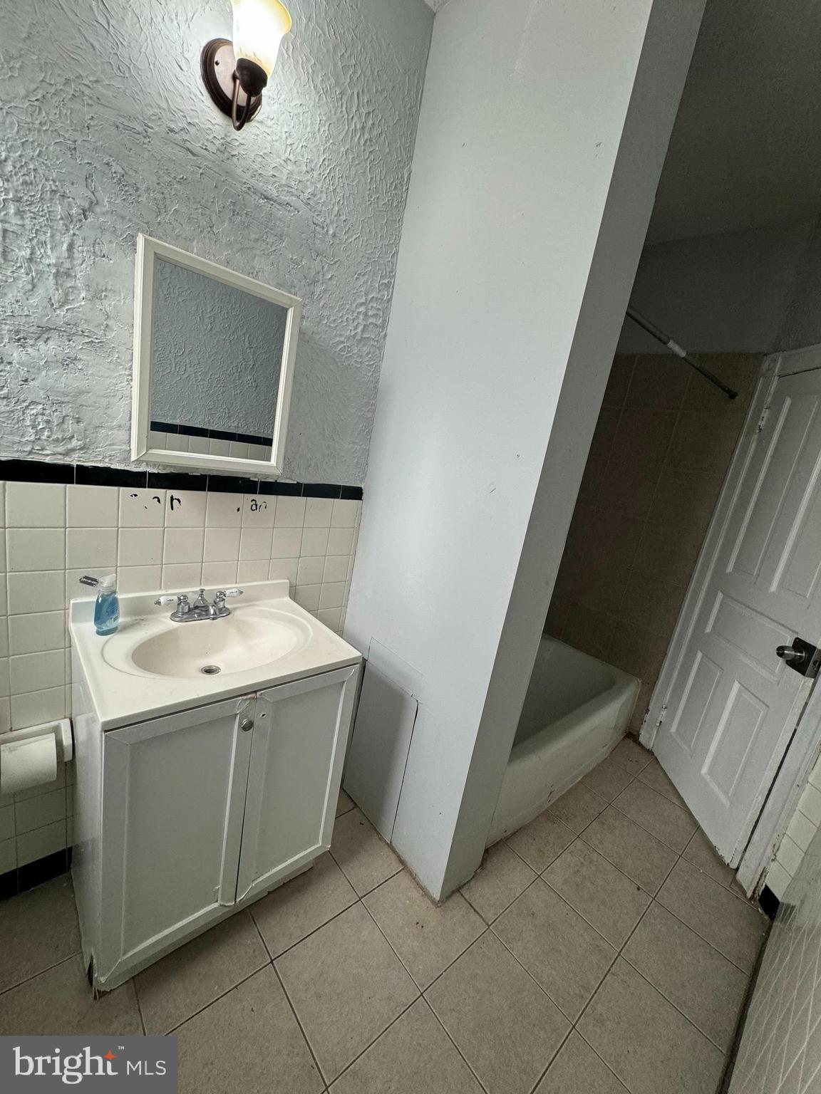 4660 Castor Avenue, Unit 2 Philadelphia, PA 19124 - Photo 10 of 11 a view of bathroom with a sink and mirror