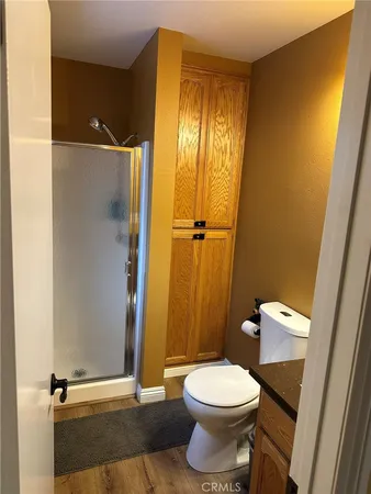 a bathroom with a toilet and a shower