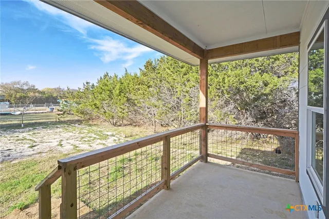 a kitchen with stainless steel appliances a stove top oven a sink dishwasher and a refrigerator with wooden floor