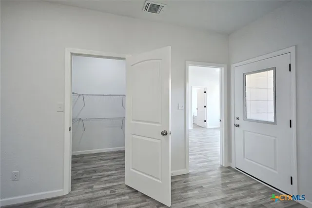 an empty room with windows and closet