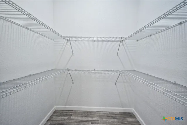 a view of an empty room and wooden floor