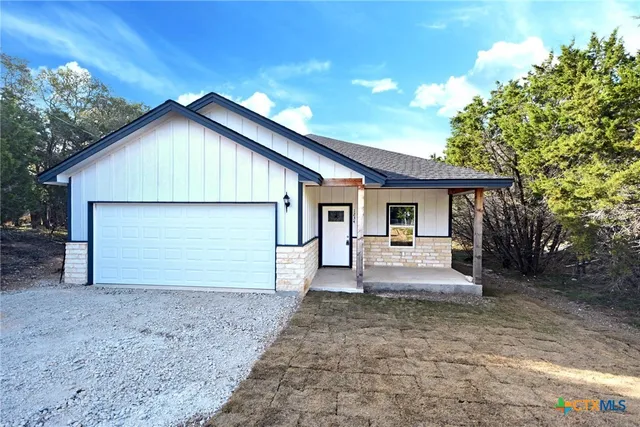 a view of a house with yard and sitting area