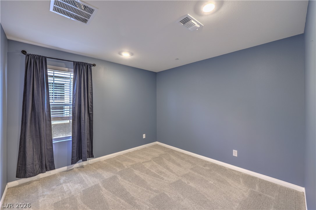 3782 Alla Rocca Avenue Henderson, NV 89044 - Photo 28 of 55 This spacious room features cozy carpeting and elegant recessed lighting, ideal for comfortable living.