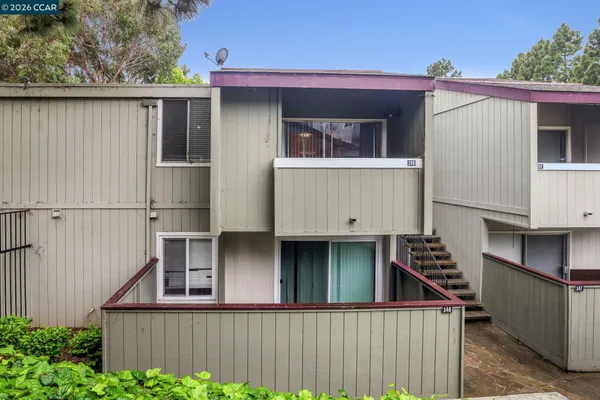 a view of a house with a garage and wooden fence
