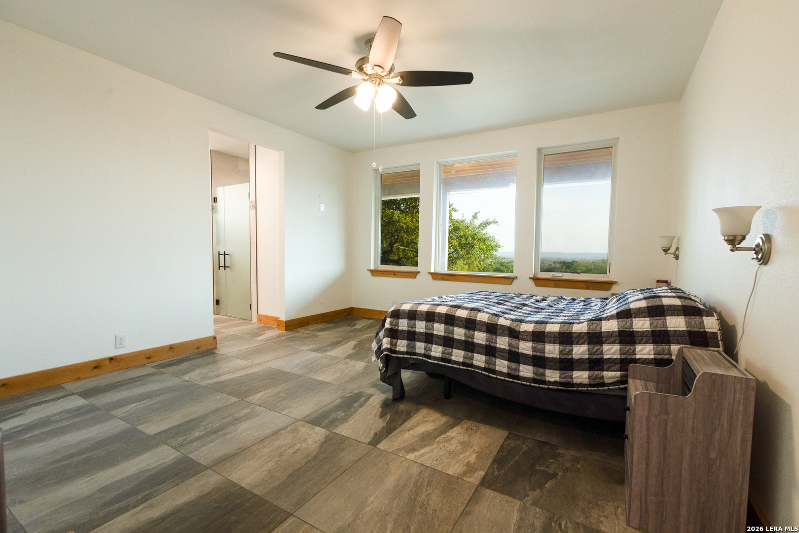 525 Windmill Drive Bandera, TX 78003 - Photo 12 of 28 a bedroom with a bed and a chandelier